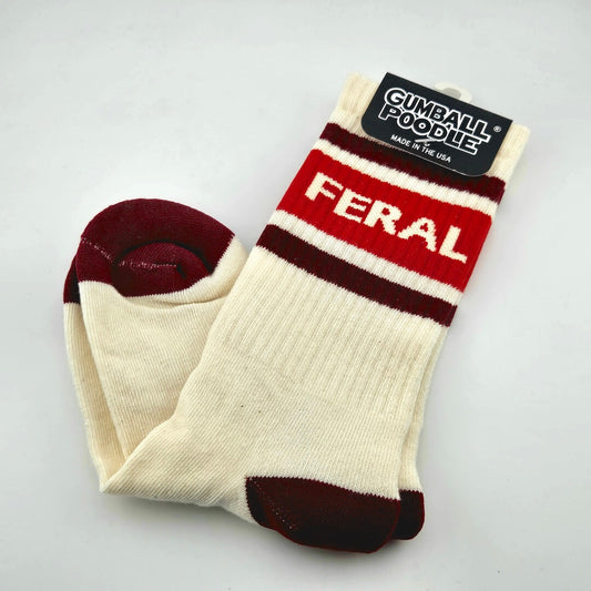 Beige socks with maroon toes and heels with maroon stripes and red banner for text, "FERAL."
