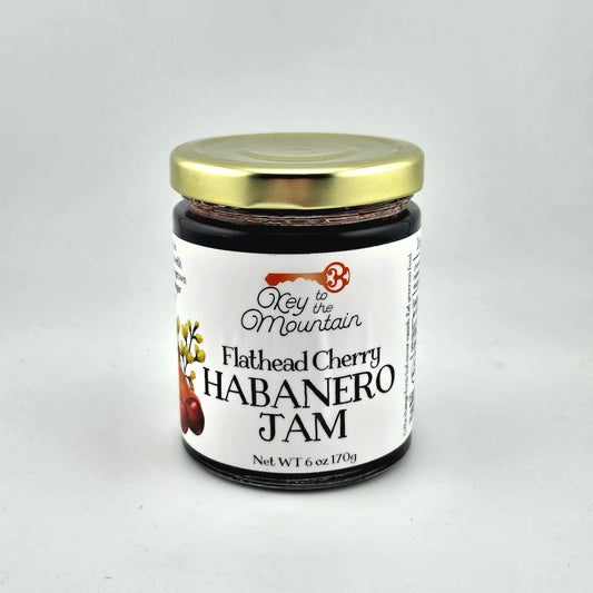 Jar of Flathead Cherry Habanero Jam with a gold lid on a white background