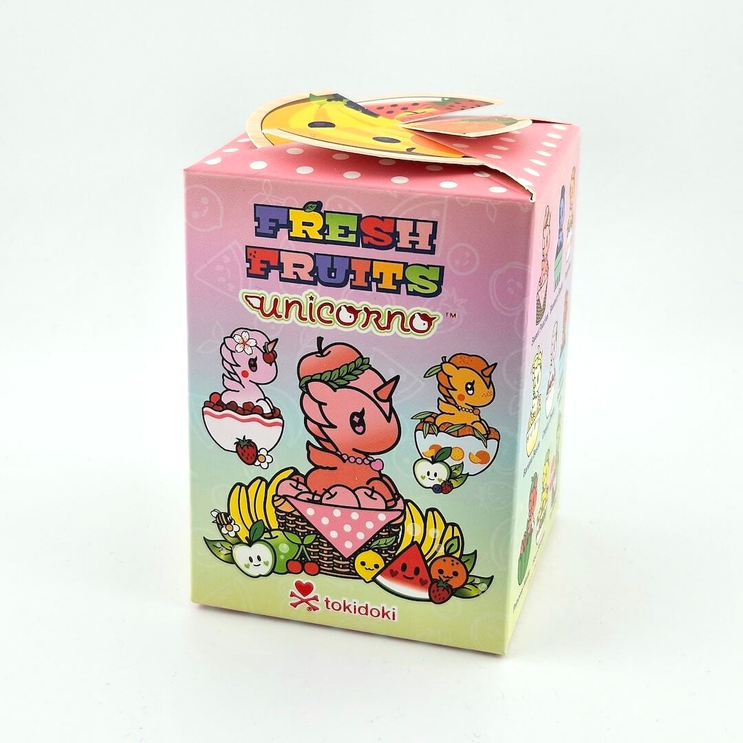 Colorful packaging of 'Fresh Fruits Unicorno' with cartoon characters on a white background