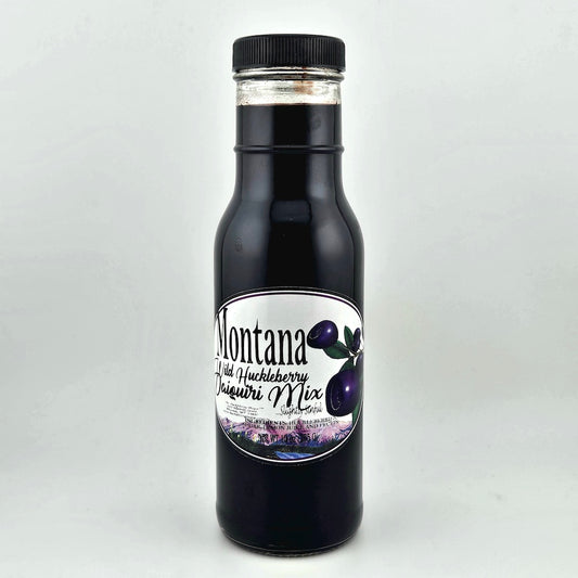 Bottle of Montana Wild Huckleberry Jam with a label on a white background