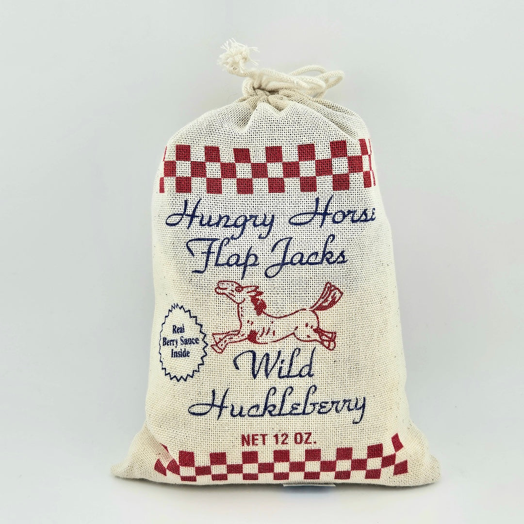 Fabric bag with 'Hungry Horse Flap Jacks' text and checkered design on a white background