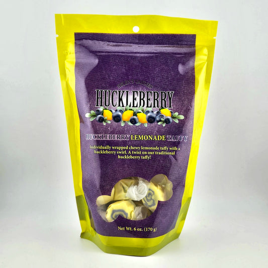 Huckleberry lemonade taffy package with purple and yellow design on a white background