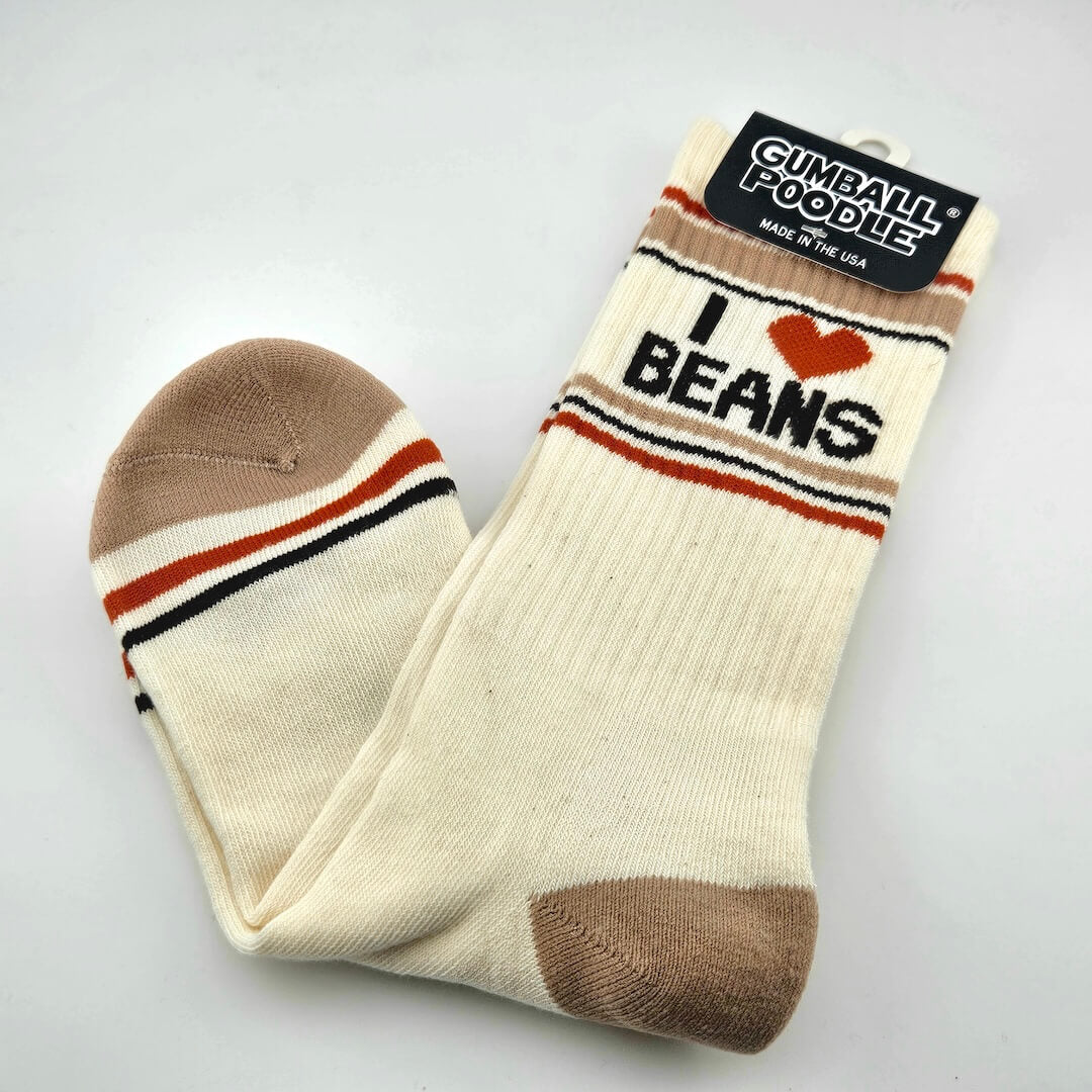 Beige socks with tan toes and heels with dark orange and tan stripes with text, "I [heart symbol] beans."