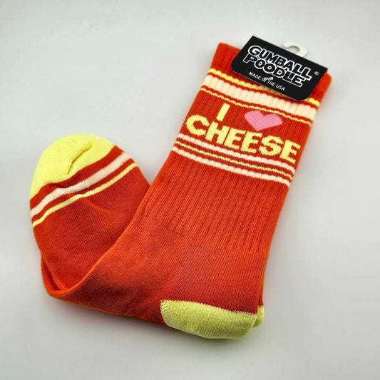 Orange socks with yellow toes and heels with beige and yellow stripes with text, "I [heart symbol] cheese."