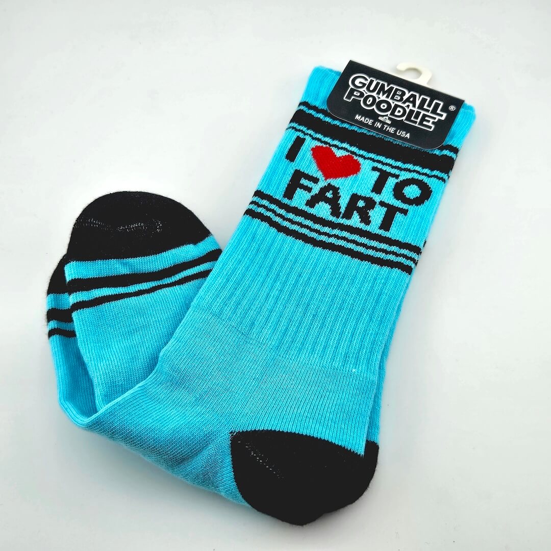Cyan blue socks with black toes, heels, stripes, and text "I [heart symbol] to Fart." 
