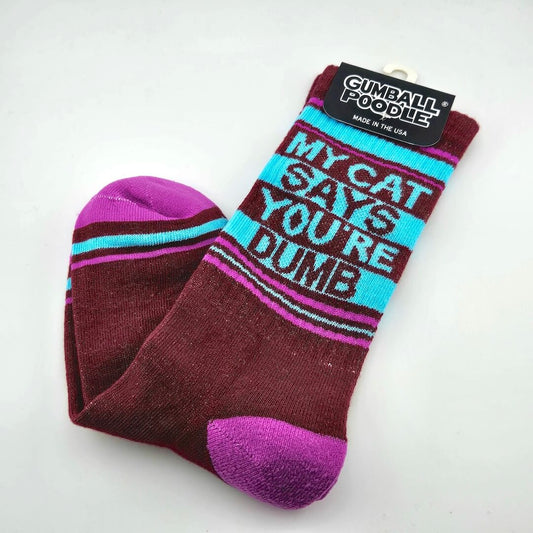 Maroon socks with fuchsia toes and heel, cyan and fuchsia stripes with text, "My cat says you're dumb."