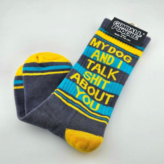 Gray socks with yellow toes and heels, yellow and blue stripes with text, "My dog and I talk shit about you."