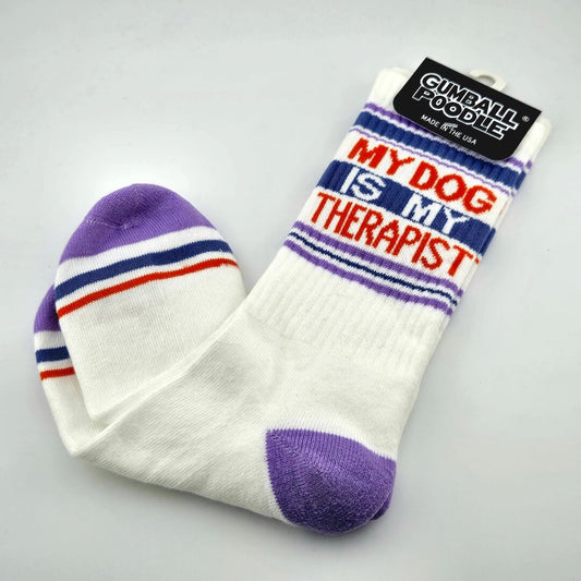 White socks with purple toes and heels, navy and red stripes with text, "MY DOG IS MY THERAPIST."