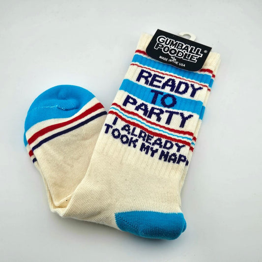 Beige socks with blue, red, and navy stripes and text, "READY TO PARTY, I ALREADY TOOK MY NAP."