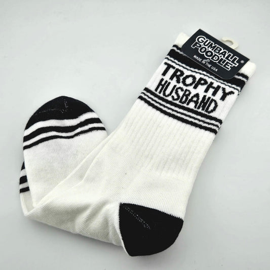 White crew socks with black toes and stripes, "TROPHY HUSBAND" across top.